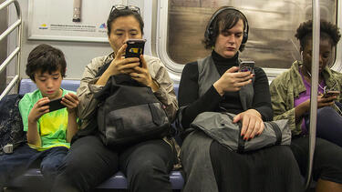 New York City subway riders using smartphones