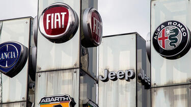 Fiat Chrysler logos at a car dealer in Turin, Italy.