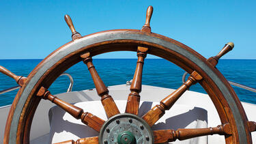 The helm of a boat at sea.
