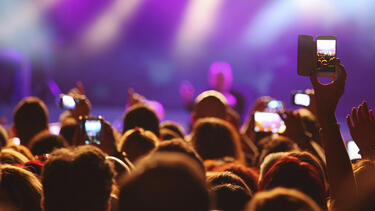 A crowd of concert-goers in front of a stage