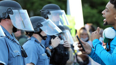 A demonstrator speaking to police officers during a protest on May 31, 2020, in Kansas City, Missouri. Photo: Jamie Squire/Getty Images.