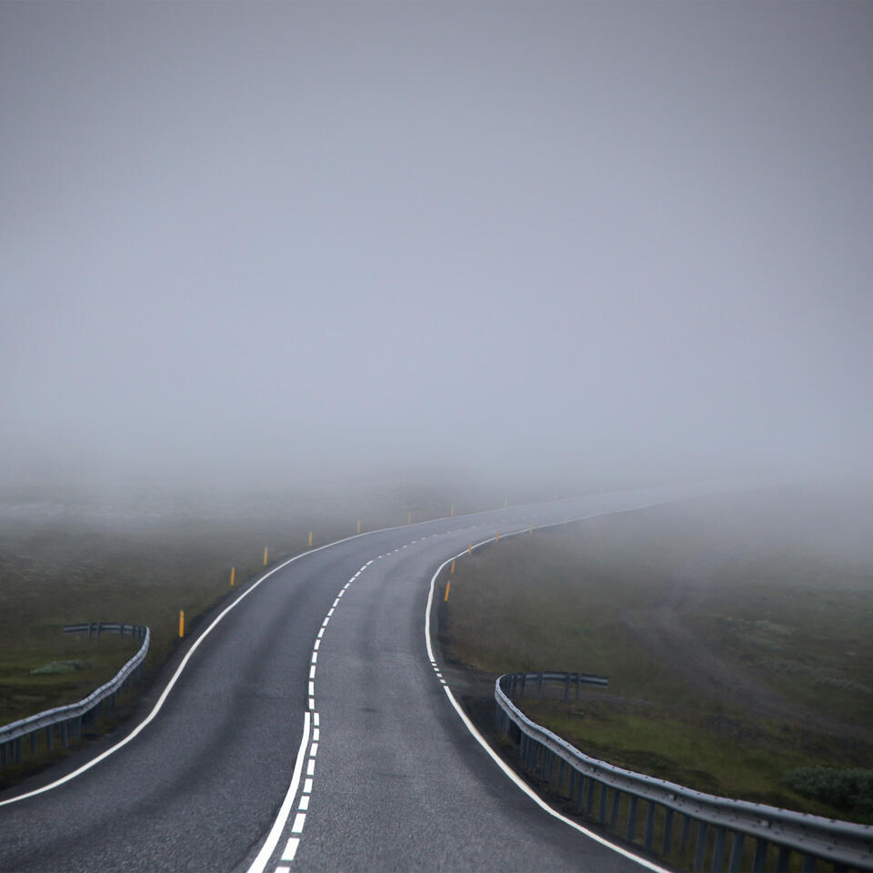 A road disappearing into fog