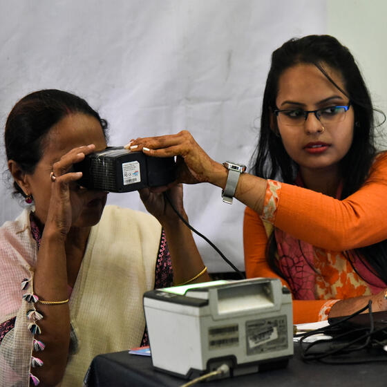 A woman having her eyes scanned at an Aadhaar registration office in Guwahati, India, in 2018. Photo: David Talukdar/NurPhoto via Getty Images.