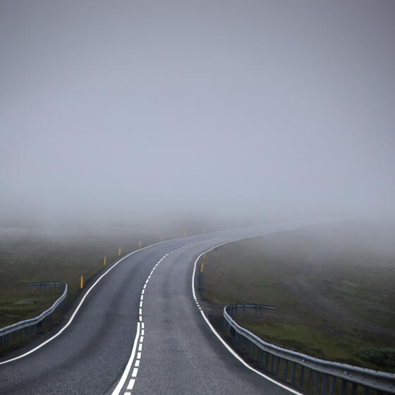 A road disappearing into fog