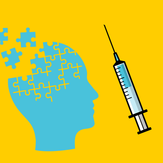 An illustration of a puzzle in the shape of a head and a syringe