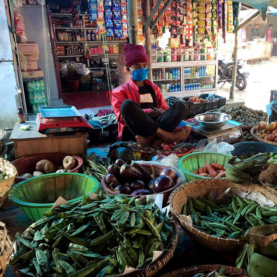 A shopkeeper in Bangladesh wearing a mask provided as part of the study