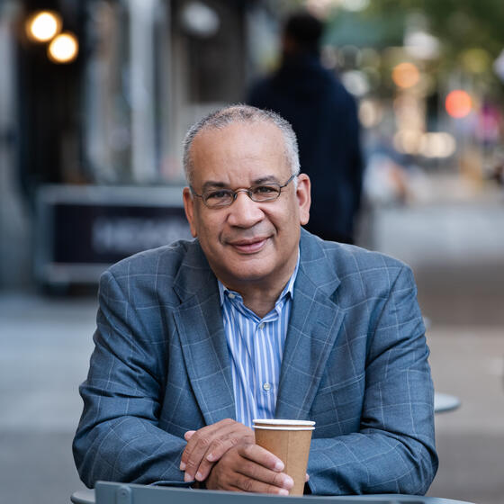 A man sitting at a table on the street in New York City