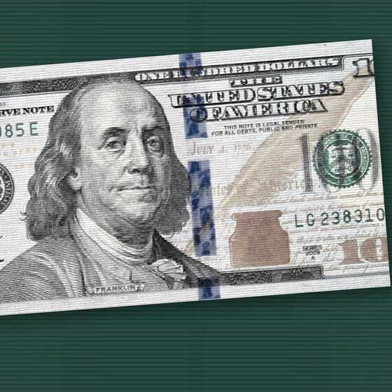 A $100 bill torn into two sections