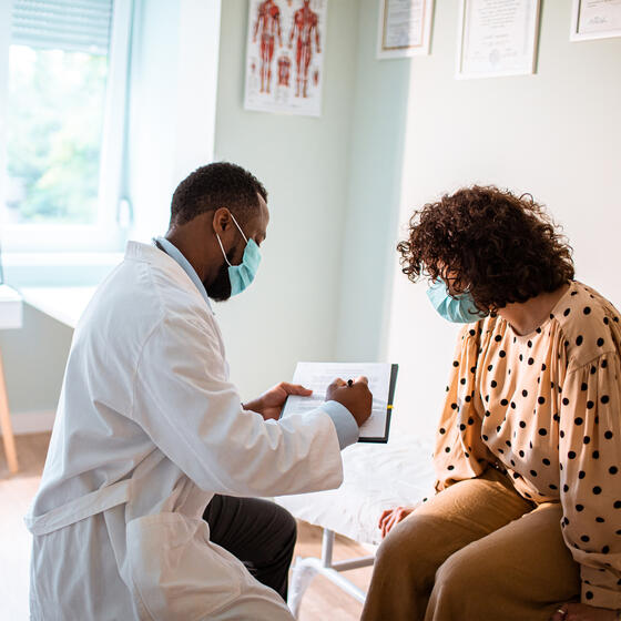 A doctor showing a chart to a patient