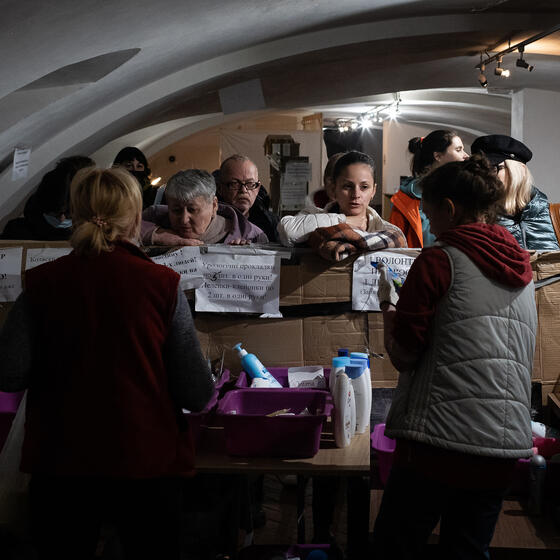 Volunteers with internally displaced people at a humanitarian aid center in Uzhhorod, Ukraine, on March 31, 2022.