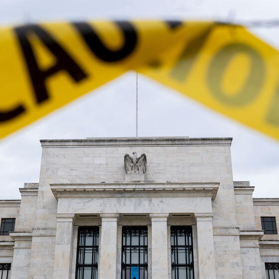The Federal Reserve building seen past caution tape