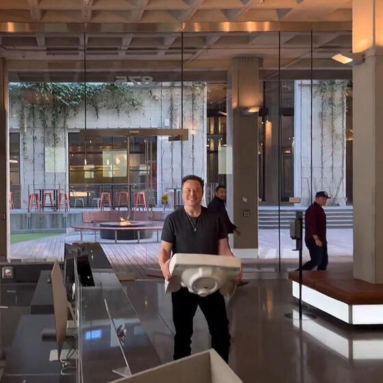 Elon Musk carrying a sink through Twitter headquarters