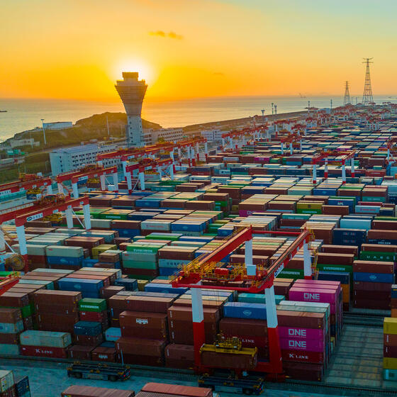 The sun setting over a vast field of shipping containers
