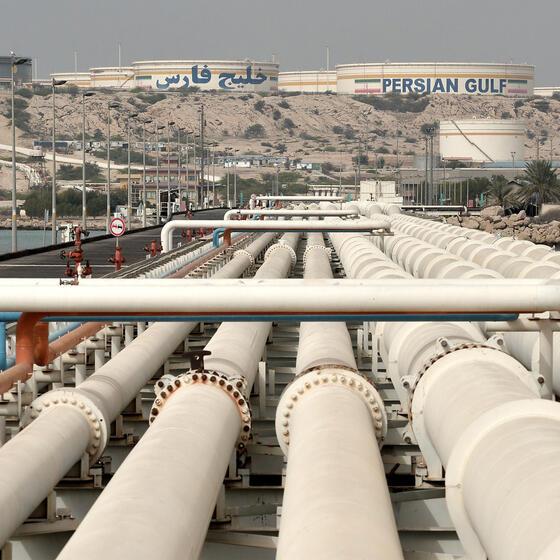 A series of oil pipelines, with oil tanks in the distance