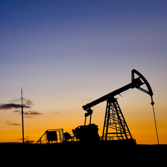 Oil pumps silhouetted against a sunset