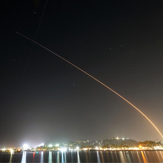 A time-lapse photo showing the arc of a rocket launch