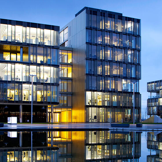 A photo of corporate headquarters campus reflected in water
