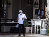 A staff member outside Fair Havens Center nursing home in Miami Springs, Florida, in May 2020. Fifty-four residents of the nursing home have died from COVID-19. Photo: Chandan Khanna/AFP via Getty Images.