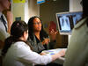 Doctors gathered around an x-ray on a computer screen