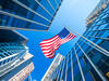 An American flag surrounded by office towers