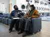 Vaccine outreach worker Herman Simmons talks to Theopulis Polk at a Chicago laundromat in March 2021.