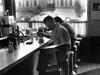 A man reading a newspaper at a diner