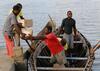 Men delivering supplies by boat