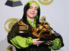 Billie Eilish with an armful of trophies at the Grammy Awards in 2020.