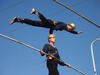 A trapeze artist balancing on the head of another trapeze artist