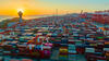 The sun setting over a vast field of shipping containers
