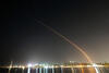 A time-lapse photo showing the arc of a rocket launch