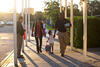 A four-year-old and her parents arriving at school