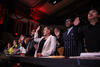 New citizens raising their right hands at a ceremony